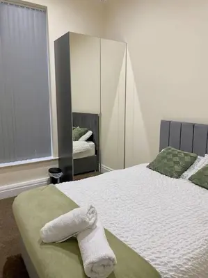 a bedroom with a bed with a towel on it at Luxury City Apartment 2 Bedroom Suite in Preston
