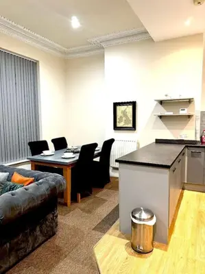 a living room with a couch and a table at Luxury City Apartment 2 Bedroom Suite in Preston