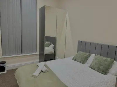 a bedroom with a bed and a large mirror at Luxury City Apartment 2 Bedroom Suite in Preston