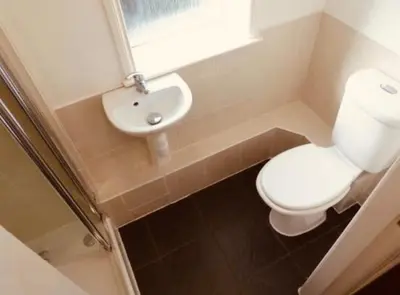 a bathroom with a white toilet and a sink at Ormskirk lets in Ormskirk