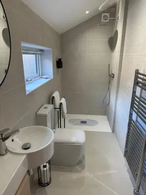 a bathroom with a toilet and a sink and a shower at The Old Wash House in Lytham St Annes