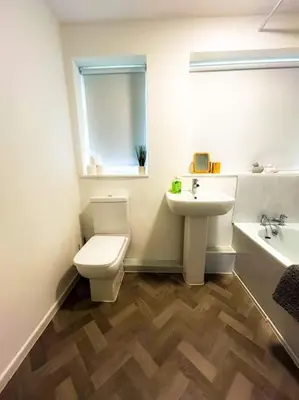 a bathroom with a toilet and a sink at 3 Double Bedrooms, Lancashire Townhouse, a base to explore in Upholland