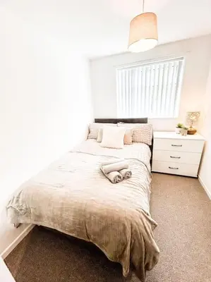 a bedroom with a bed and a window at 3 Double Bedrooms, Lancashire Townhouse, a base to explore in Upholland