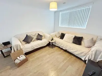 a living room with a white couch in a room at 3 Double Bedrooms, Lancashire Townhouse, a base to explore in Upholland