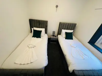 two beds sitting next to each other in a room at The New Valeron Hotel in Blackpool