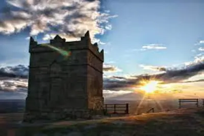 an old castle with the sunset in the background at Cheerful 2 bedroom town house in Lancashire in Chorley