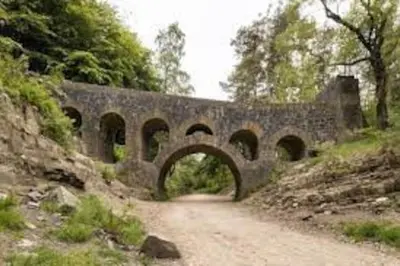 a stone bridge over a dirt road on a hill at Cheerful 2 bedroom town house in Lancashire in Chorley
