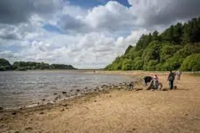a group of people on a beach near the water at Cheerful 2 bedroom town house in Lancashire in Chorley