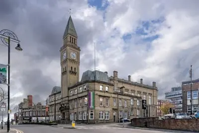 a building with a clock tower on top of it at Cheerful 2 bedroom town house in Lancashire in Chorley