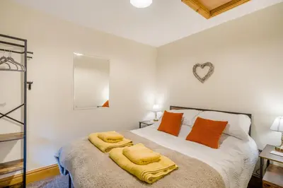 a bedroom with a bed with orange pillows at 2 Bed in Oakenclough oc-m30216 in Scorton