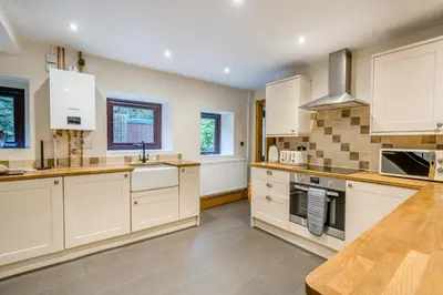a large kitchen with white cabinets and a counter top at 2 Bed in Oakenclough oc-m30216 in Scorton