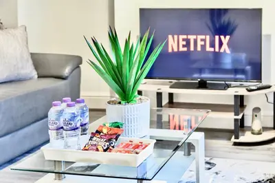 a coffee table in a living room with a tv at Large 6 Bed House, Long Term Stay Savings, Contractors, Professionals, Big Groups, Free Parking! in Liverpool
