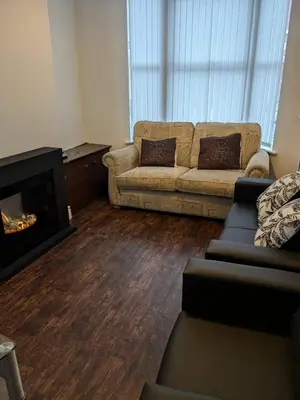 a living room with a couch and a fireplace at Best homestay Close To City Centre in Liverpool
