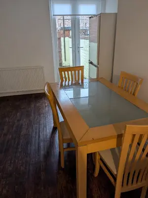 a dining room with a table and chairs and a window at Best homestay Close To City Centre in Liverpool