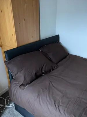 a bed with two pillows on it in a room at Best homestay Close To City Centre in Liverpool