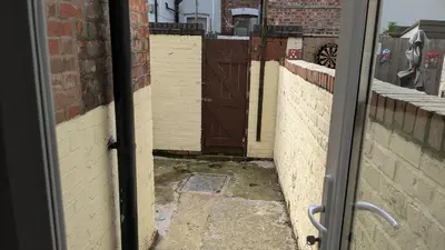 a view from a door of an alley with a gate at Best homestay Close To City Centre in Liverpool