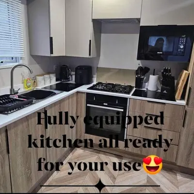 a kitchen with a sink and a stove at Escape in Carnforth Lodge - Sleeps 6 in Carnforth