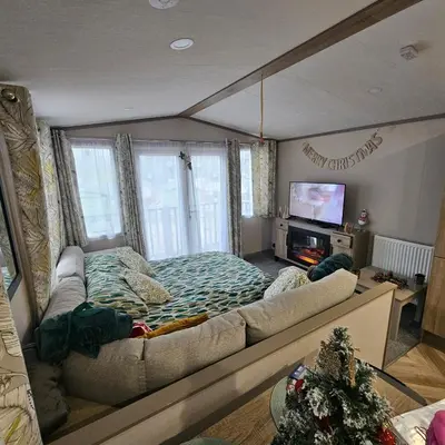 a living room with a large bed and a television at Escape in Carnforth Lodge - Sleeps 6 in Carnforth