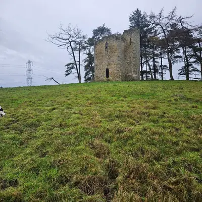an old building on top of a grassy hill at Escape in Carnforth Lodge - Sleeps 6 in Carnforth