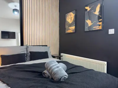 a stuffed animal laying on top of a bed at TV Every Bedroom 4 Bed 2 Bath Free Parking in Liverpool