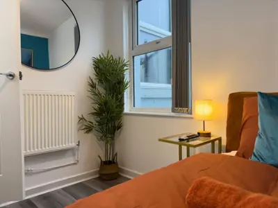 a living room with a couch and a mirror at TV Every Bedroom 4 Bed 2 Bath Free Parking in Liverpool