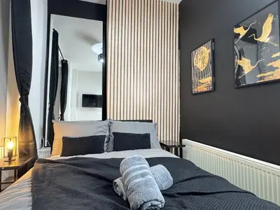 a bedroom with a bed with a towel on it at TV Every Bedroom 4 Bed 2 Bath Free Parking in Liverpool