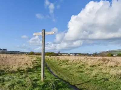 a street sign in the middle of a field at Cookies Corner in Millom