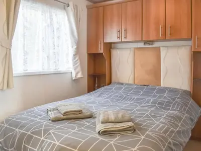 a bedroom with a bed with two towels on it at Cookies Corner in Millom