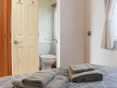 a bedroom with a bed with towels on it at Cookies Corner in Millom