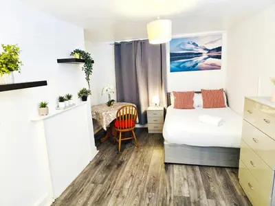 a small bedroom with a bed and a table at Specious Liverpool Central Apartment in Liverpool
