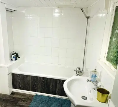 a bathroom with a tub and a sink at Specious Liverpool Central Apartment in Liverpool
