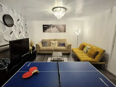 a living room with a ping pong table in the middle at Specious Liverpool Central Apartment in Liverpool