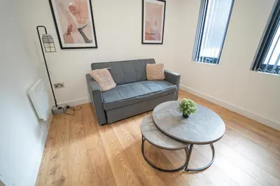 a living room with a couch and a table at Sevenstay Apartments Fleet Street in Liverpool