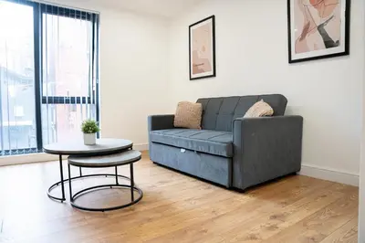 a living room with a couch and a table at Sevenstay Apartments Fleet Street in Liverpool