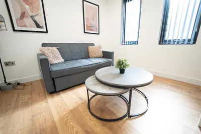 a living room with a couch and a table at Sevenstay Apartments Fleet Street in Liverpool