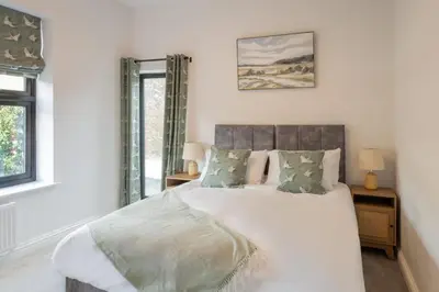 a bedroom with a large bed with white sheets and pillows at Host & Stay - Bay View House in Grange Over Sands