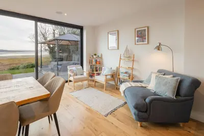 a living room with a couch and a table and chairs at Host & Stay - Bay View House in Grange Over Sands