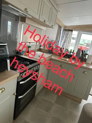 a kitchen with a sign that says happy new special season at Holiday escapes by the bay in Heysham