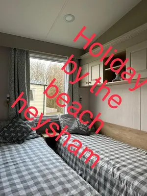 two beds in a bedroom with the words your new bedroom at Holiday escapes by the bay in Heysham