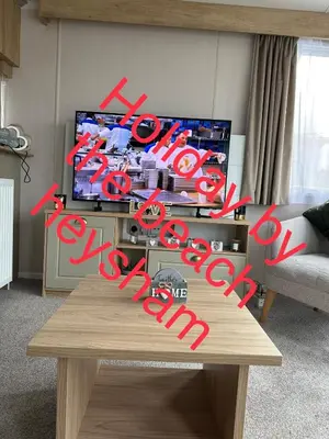 a living room with a coffee table and a tv at Holiday escapes by the bay in Heysham