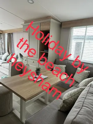 a living room with a table and a couch at Holiday escapes by the bay in Heysham