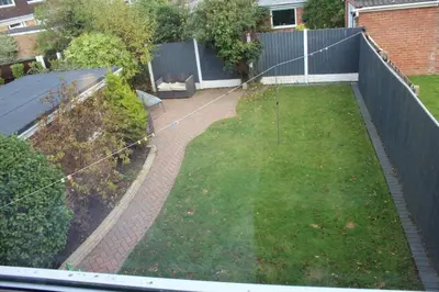 an aerial view of a garden with a fence at Beautiful home near beach in Formby
