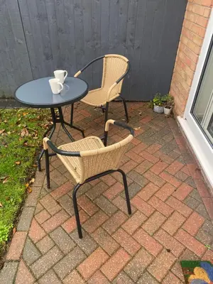 a table and chairs on a brick patio at Beautiful home near beach in Formby
