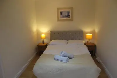 a bedroom with a bed with two towels on it at Beautiful home near beach in Formby