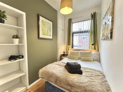 a small bedroom with a bed and a window at Modernised 3-bed home in Bamber Bridge, Preston in Bamber Bridge