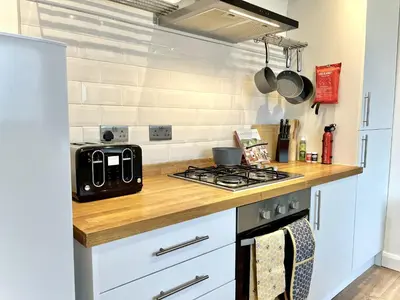 a kitchen with a counter top with a stove top oven at Modernised 3-bed home in Bamber Bridge, Preston in Bamber Bridge