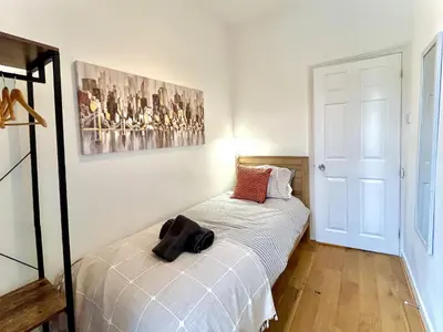 a small bedroom with a bed with white sheets at Modernised 3-bed home in Bamber Bridge, Preston in Bamber Bridge