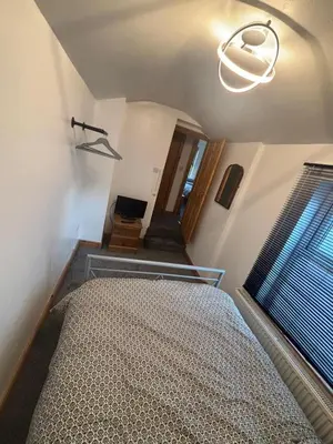 a bedroom with a bed and a window at Morecambe Bay Cottage in Morecambe