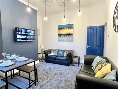 a living room with two couches and a table at Ideal 4-bed stay-away-home sleeps 6 in Preston in Preston