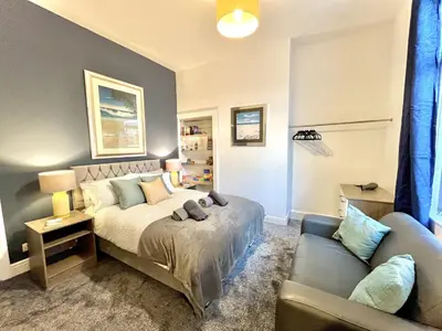 a bedroom with a bed and a couch at Ideal 4-bed stay-away-home sleeps 6 in Preston in Preston